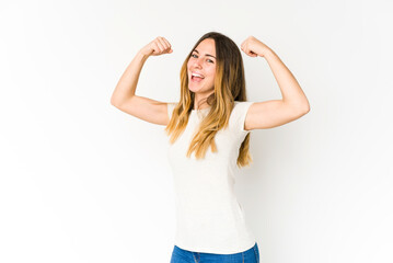 Fototapeta na wymiar Young caucasian woman isolated on white background raising fist after a victory, winner concept.