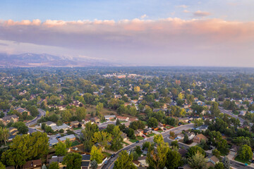 hazy morning with wildfire smoke from Cameron Peak Fire over Fort Collins in northern Colorado, aerial view