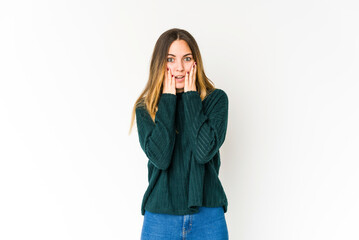Young caucasian woman isolated on white background shocked, covering mouth with hands, anxious to discover something new.