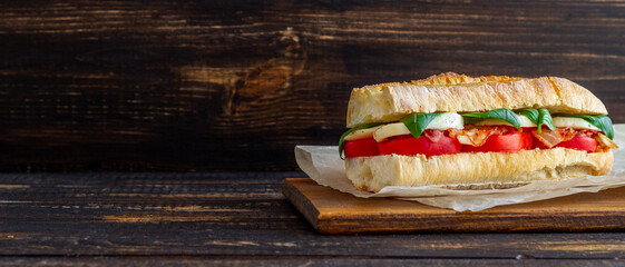 Caprese sandwich with tomatoes, mozzarella, basil and bacon. Healthy eating. Italian cuisine.