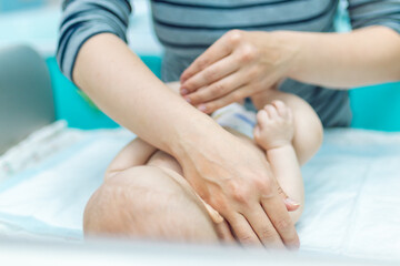 Fototapeta na wymiar Baby massage closeup. Mother and child. Newborn.