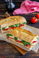 Caprese sandwich with tomatoes, mozzarella, basil and bacon. Healthy eating. Italian cuisine.