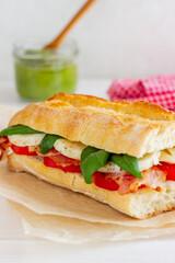 Caprese sandwich with tomatoes, mozzarella, basil and bacon. Healthy eating. Italian cuisine.