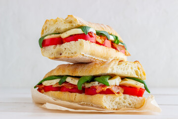 Caprese sandwich with tomatoes, mozzarella, basil and bacon. Healthy eating. Italian cuisine.
