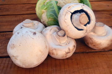 Porcini mushrooms, champignons on a wooden background.