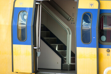 Closeup of a train waiting at platform, with open doors