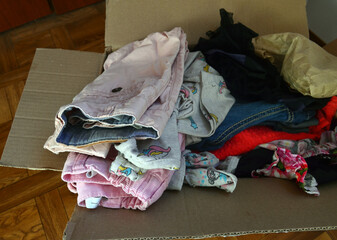 Baby things are packed in a box when moving.