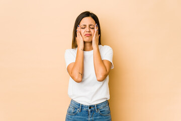 Young woman isolated on beige background whining and crying disconsolately.