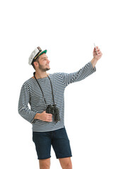Taking selfie. Caucasian male sailor in uniform on white studio background. Young man using modern devices and gadgets in his work. Concept of tech, professional occupation, job of seaman.
