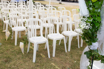 white empty chairs on lawn ready for secular wedding ceremony