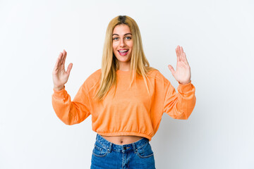 Fototapeta na wymiar Young blonde woman isolated on white background holding something little with forefingers, smiling and confident.