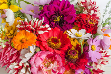 Colorful bouquet of garden flowers close-up on a white background.