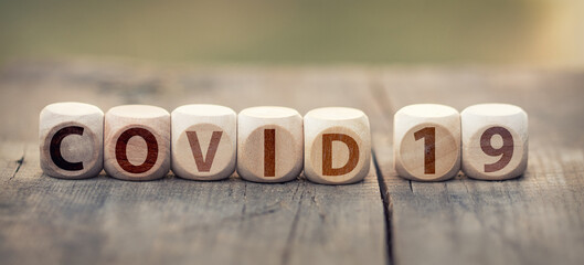 The word Covid 19 on wooden cubes