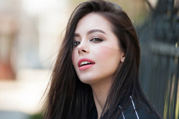 Fototapeta premium Beautiful fashion woman portrait outdoor with perfect dark hair