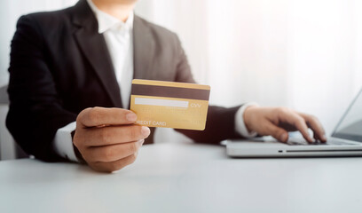 businesswoman hand using smart phone, tablet payments and holding credit card online shopping, omni channel, digital tablet docking keyboard computer at office in sun light