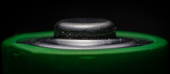 Extreme macro close up of the positive terminal of a AA battery cell