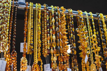 Variety assortment of souvenirs made of amber, traditional tourist souvenirs and gifts from Kaliningrad, Russia, in local vendor souvenir shop