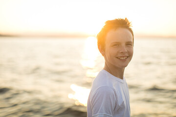 Portrait of smiling teen boy at the beach at sunset © Crystal Madsen