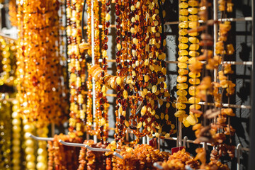 Variety assortment of souvenirs made of amber, traditional tourist souvenirs and gifts from Kaliningrad, Russia, in local vendor souvenir shop