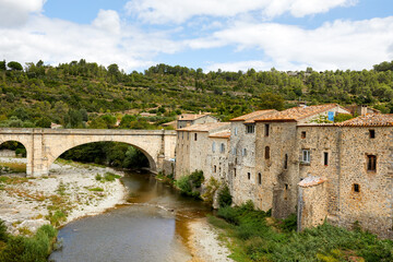 Fototapeta na wymiar Medieval houses and an old bridge over the river Orbieu in Lagrasse, South of France.