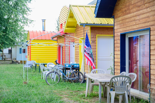 colored houses with garden, bicycle and american flag