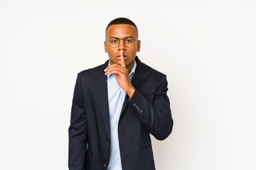 Young business latin man isolated on white background keeping a secret or asking for silence.
