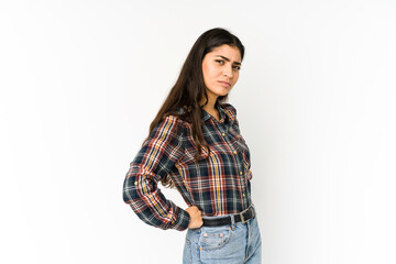 Young indian woman isolated on purple background frowning face in displeasure, keeps arms folded.