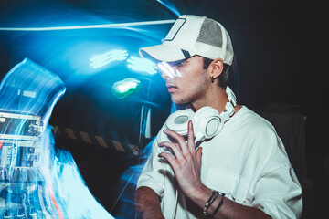 Charismatic disc jockey at the turntable. DJ plays on the best, famous CD players at nightclub during party. EDM, party concept.