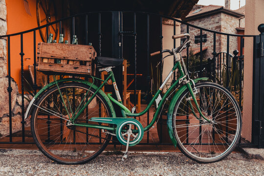 Old bike. Farmhouse. Rustic rural scene in the center of Spain. Transportation parked at the door. Europe.