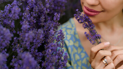 Woman holding a bouquet from lavender flowers in the lavender field