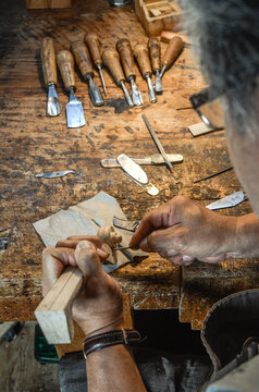 Violin maker luthier hand working a new violin scroll