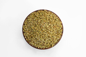 Fresh coriander seeds in wooden bowl and white background.