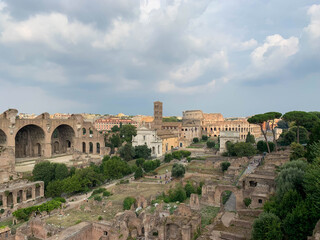 Fototapeta na wymiar Landscape panoramic view of the Roman Forum - Basilica Nova and The Colosseum in Rome, Italy 