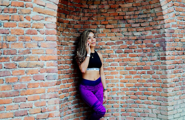 woman with braids talking on her smartphone