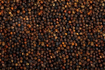 Black pepper seeds as background texture.