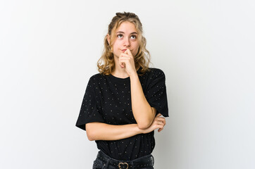 Young caucasian woman on white backrgound relaxed thinking about something looking at a copy space.