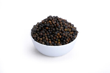 Black pepper seeds in white bowl and white background.