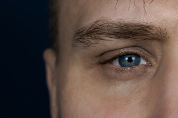 Male eye close up. The face of a young man.