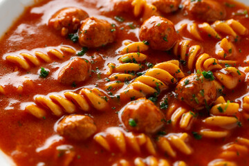Italian tomato soup with meatballs and noodles