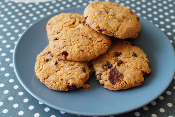 Breakfast at home with the family. Chocolate cookies served on a ceramic plate on the kitchen table.