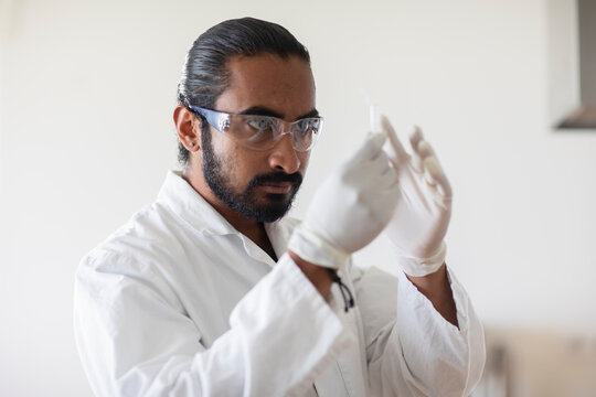 young man scientist  with lab coat checking a sample