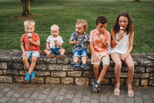 White family and kids eating ice cream together during holidays