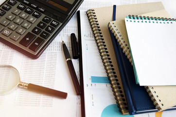Business documents on an office desk with a calculator and pencil as a business concept of a workspace. With cloud exposure