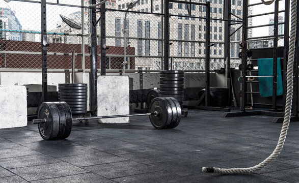 barbell and weights  at empty rooftop gym in Bangkok