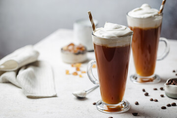 Iced coffee in a tall glasses with cream poured over