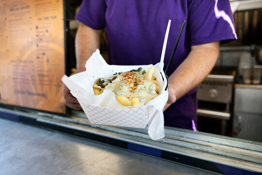 Food Truck: Chef Holds Paper Boat With Loaded Fries