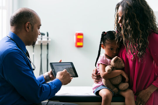 Exam: Doctor Discusses History With Mother Of Young Girl