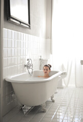 beautiful woman relaxing in bathtub