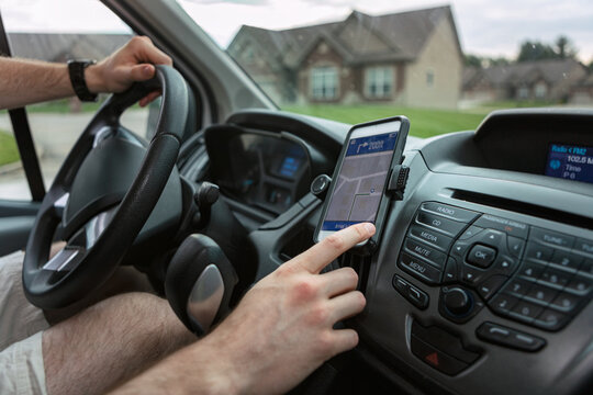 Shipping: Delivery Man Uses Cell Phone For Directions