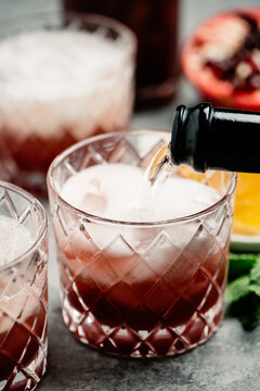 Pouring Sparkling Wine into a Pomegranate Cocktail